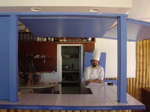 Valter at the kitchen window at Trattoria, April 2003. Chantal found him through Luciano — a young chef from Villa Minozzo, Modena who had never heard of Anguilla.